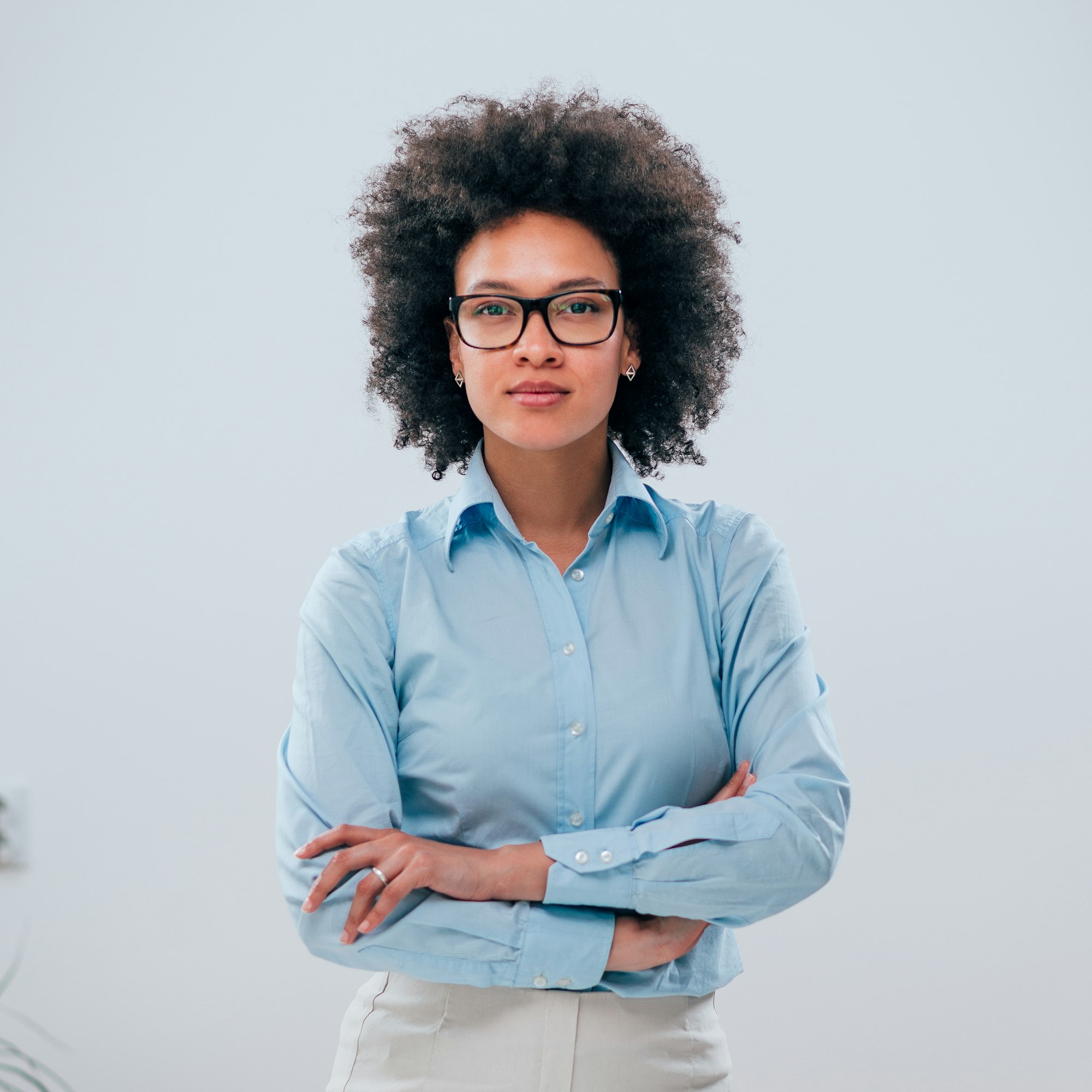 portrait of a confident businesswoman with curly hair on isolated background Page