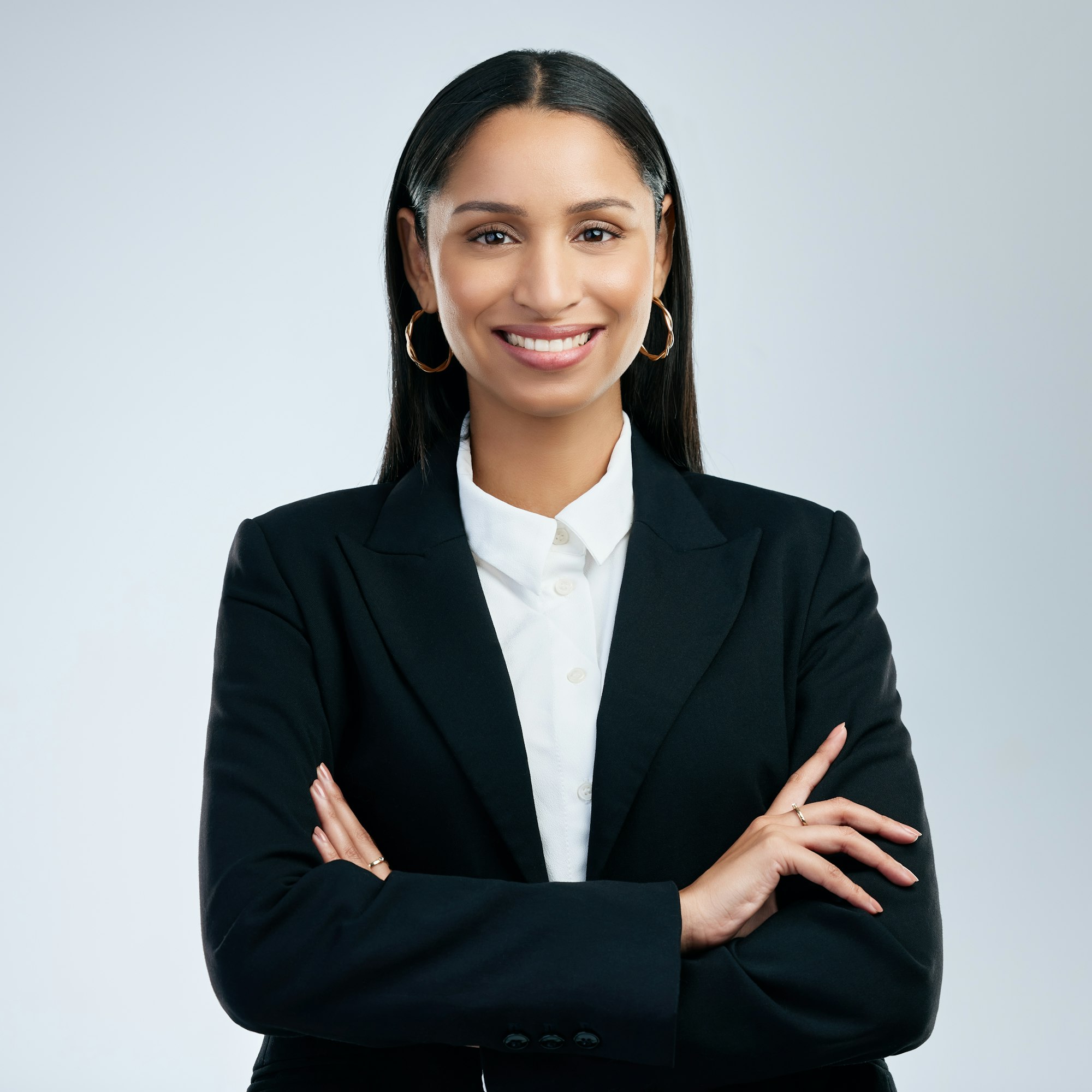 shot of a confident young businesswoman standing against a grey background Page