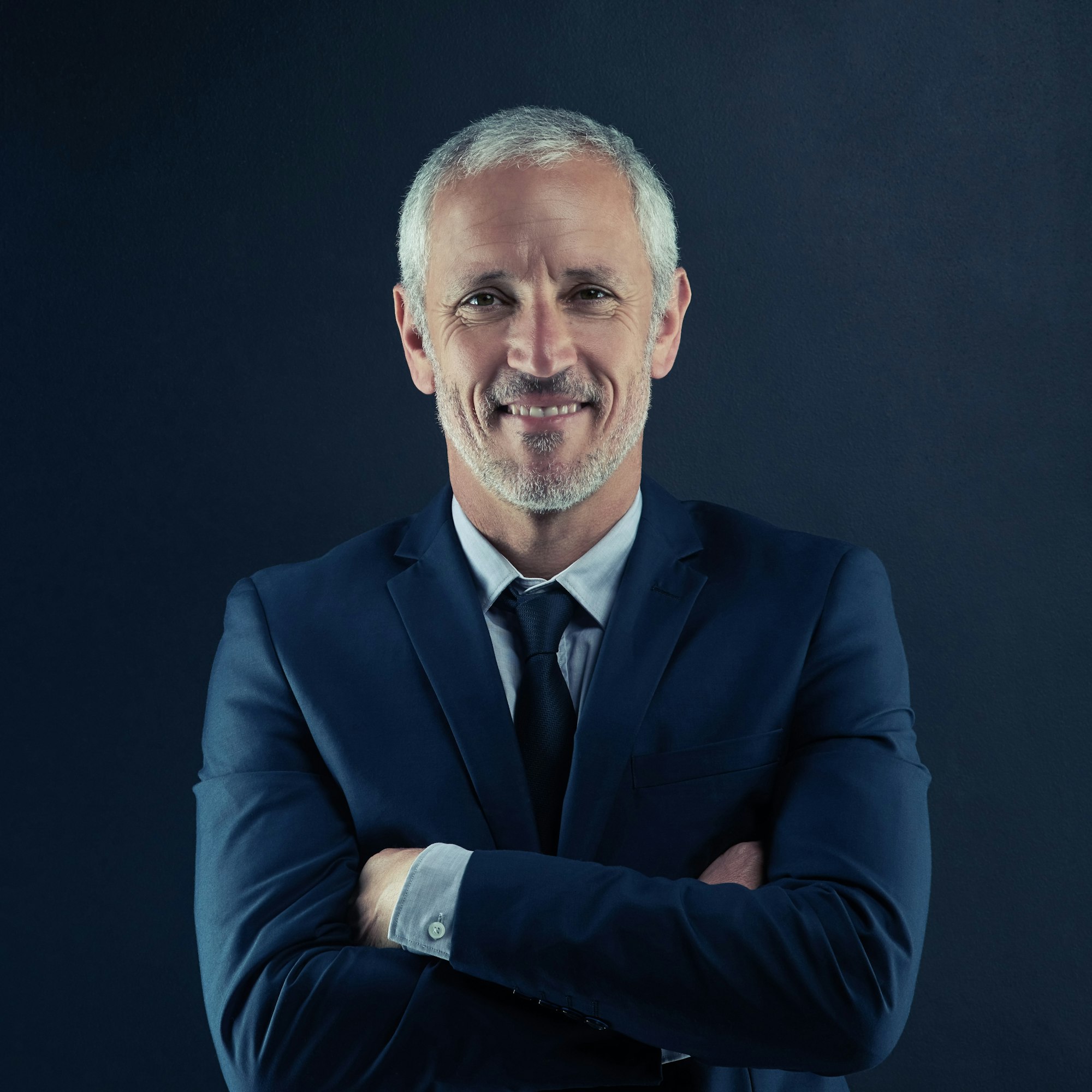studio portrait of a mature businessman against a dark background Page
